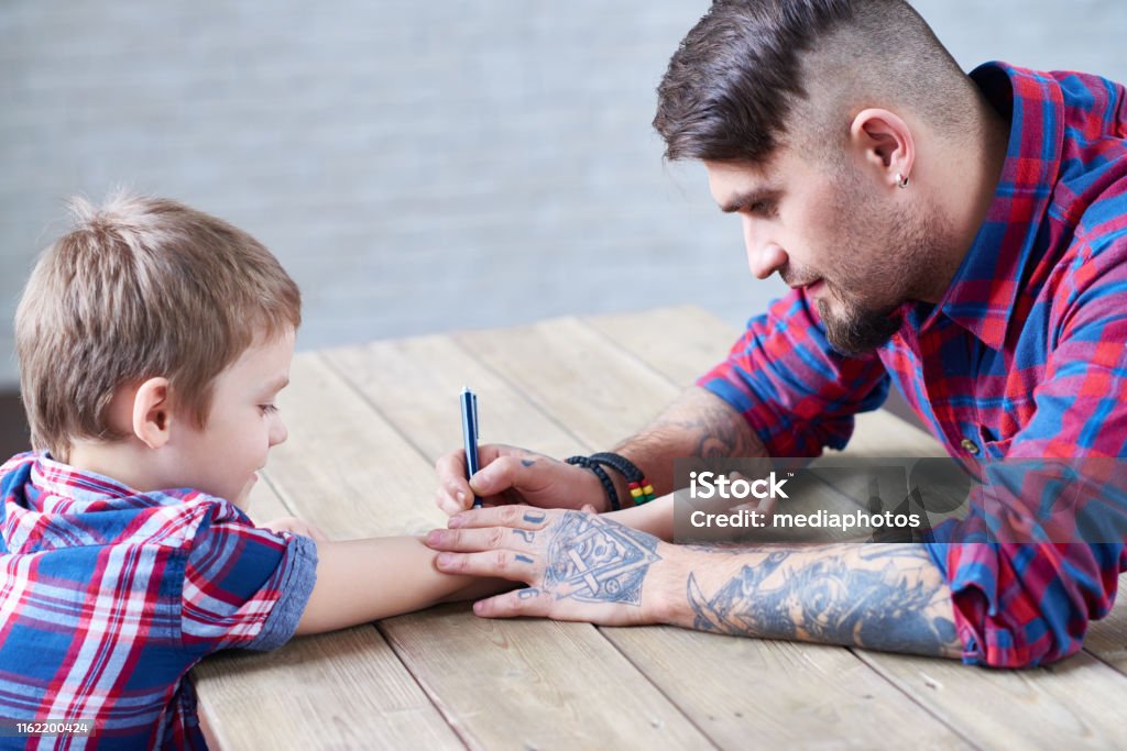 Man Drawing Temporary Tattoo On Kids Hand Stock Photo - Download Image Now  - Beard, Men, Side View - iStock