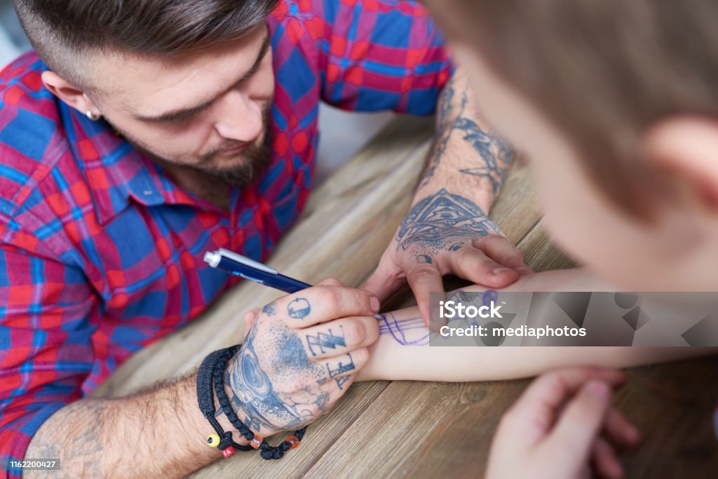 Man Drawing Cool Tattoo With Pen Stock Photo - Download Image Now - Tattoo, Temporary, Pen - iStock Man Drawing Cool Tattoo With Pen Stock Photo - Download Image Now - Tattoo, Temporary, Pen - iStock