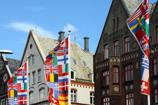 european flags in front of old hansa houses in Bergen, Norway