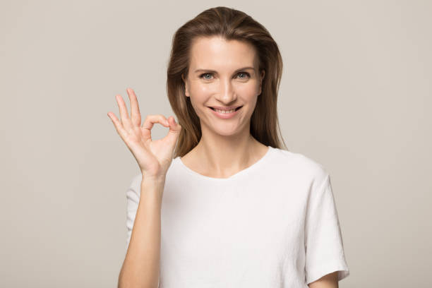 istock Confident smiling young woman, satisfied client showing ok gesture 1162203148