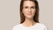 Close up head shot portrait confident young woman in glasses
