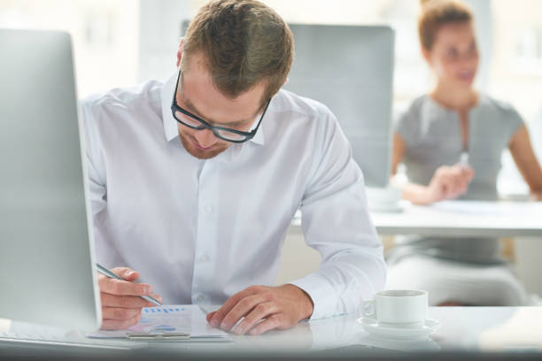 istock Concentrated businessman working with paper 1162204487
