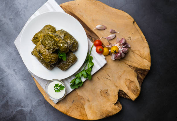 istock Traditional georgian dolma in grape leaves on rustic wooden table with copyspace 1162205051