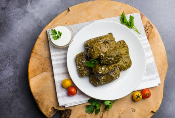 istock Traditional georgian dolma in grape leaves on rustic wooden table with copyspace 1162205058