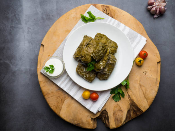 istock Traditional georgian dolma in grape leaves on rustic wooden table with copyspace 1162205067
