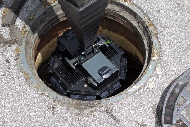 Digital 3D manhole inspection camera Inspection camera being lowered into sewer manhole for 3d digital examination sewer photos stock pictures, royalty-free photos & images