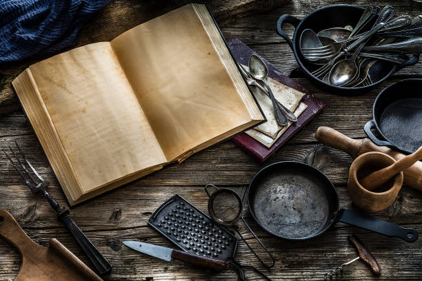 istock Vintage cookbook with kitchen utensils 1162206029