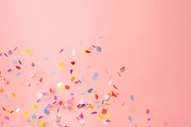 Colorful confetti on pastel pink background. Bright and festive holiday background. Colorful confetti on pink background. Copyspace for text. Bright and festive holiday background. For Mother's day and birthday cellebration carnival celebration event photos stock pictures, royalty-free photos & images