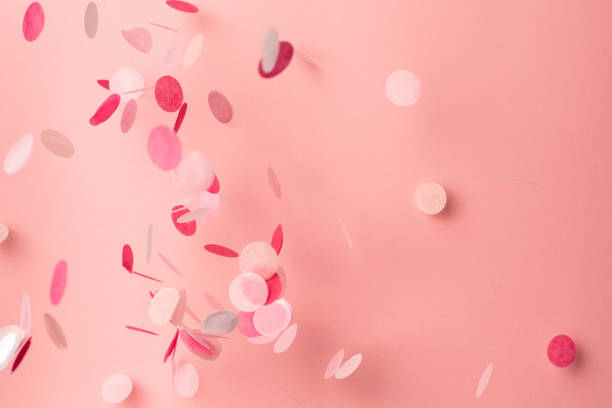 istock Pink confetti on pink background. Copyspace for text. Bright and festive holiday background. 1162206153