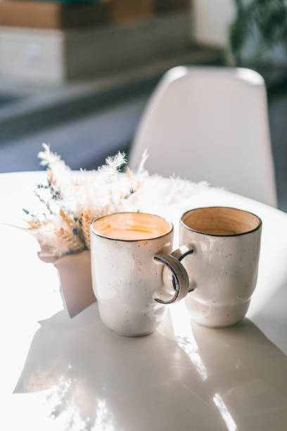 istock The cup of coffee flat white on the white table 1162206289