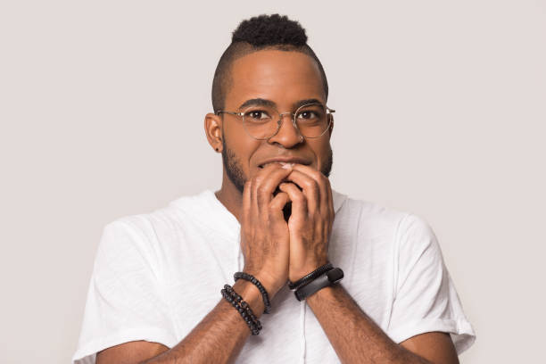 istock Nervous mixed race guy feeling fear studio shot 1162206910