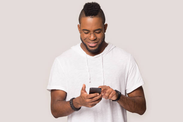istock African guy using smartphone chatting with friend studio shot 1162206918