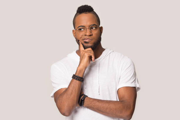 istock Doubting african guy thinking indoors studio shot 1162206919