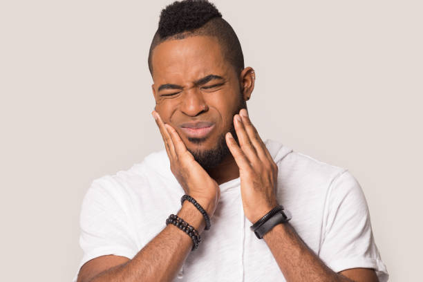 istock Millennial black man suffering from sudden strong toothache 1162206921