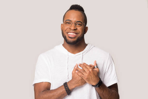 istock Grateful handsome young black man demonstrating thankful gesture. 1162206923