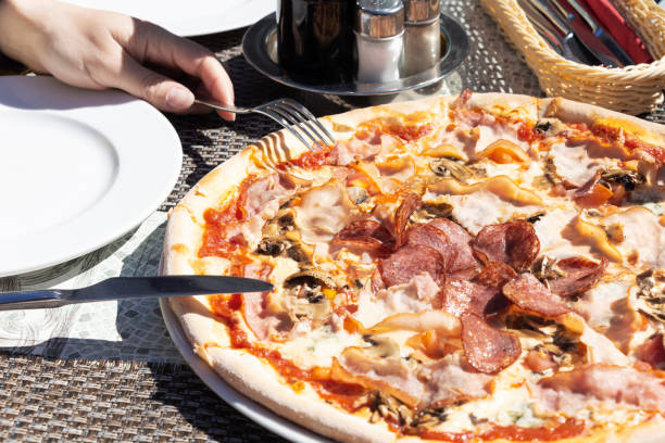 istock pizza with pepperoni, salami, pepper, cheese, close-up. 1162206935