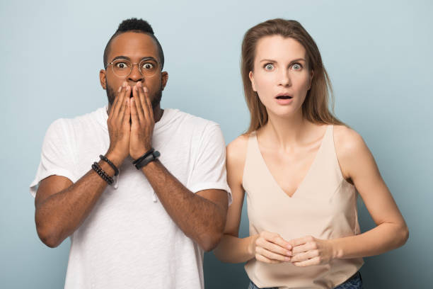 istock Shocked diverse young couple looking at camera. 1162206949