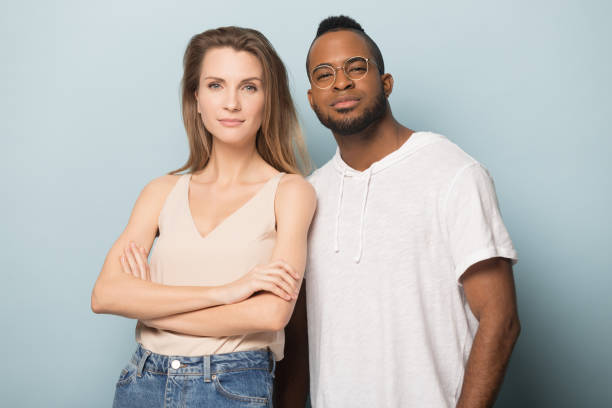 istock Attractive multiracial couple posing for photo in studio. 1162206975