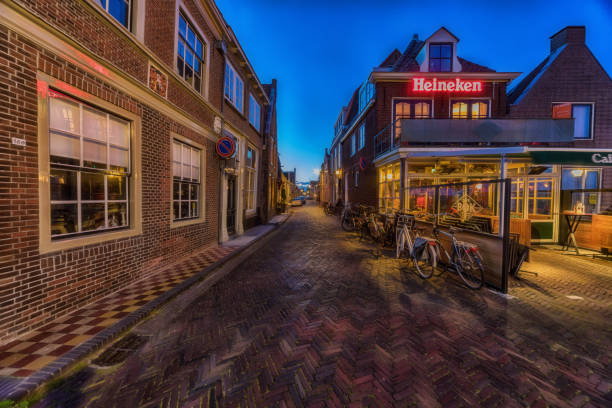 Old street in Enkhuizen at the IJsselmeer in the Netherlands during dusk. Enkhuizen, The Netherlands - May 04, 2019: Old street in Enkhuizen at the IJsselmeer in the Netherlands during dusk. enkhuizen stock pictures, royalty-free photos & images