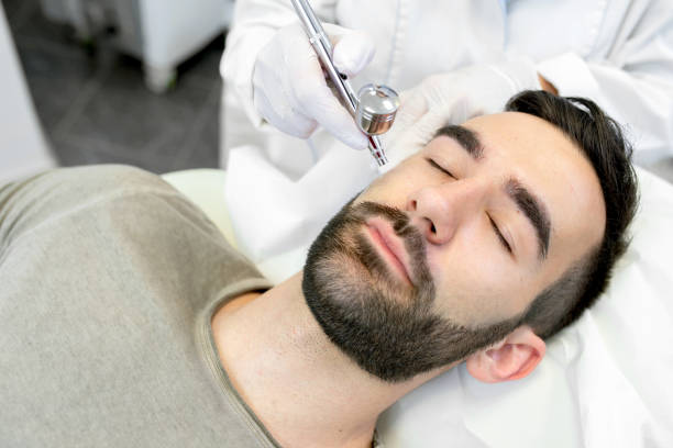 Young Man in the Beauty Salon During Oxygen Face Treatment - fotografia de stock