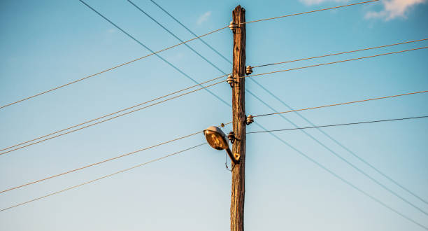 istock Old wooden electric pole with cables 1162209466