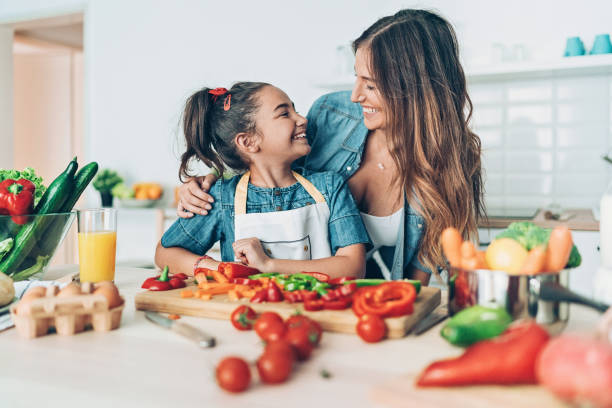 istock Happy mother and daughter in the kitchen 1162210646
