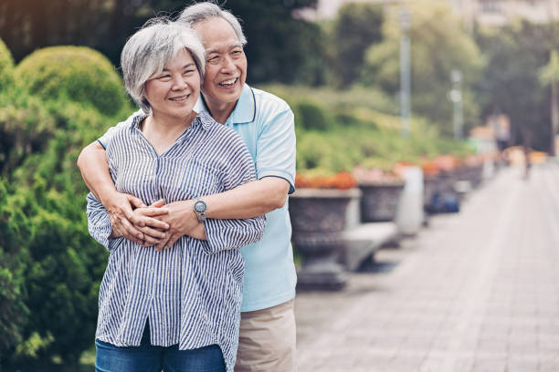 istock Happy senior couple embracing in a park 1162210654