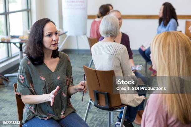 Women Break Into Small Groups To Share Information Stock Photo - Download Image Now - Determination, Support, African-American Ethnicity