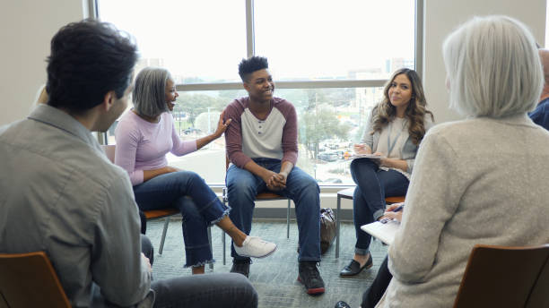 istock Grandmother smiles as therapy group helps teen boy with problems 1162213372
