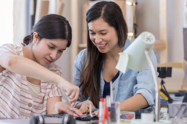 istock Teenage girl uses tool while repairing computer 1162213443
