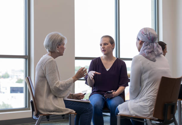 istock Two women discuss cancer issues as third woman looks on 1162213611
