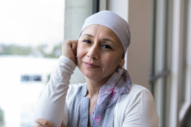 le patient de cancer utilisant une écharpe pour couvrir la tête semble paisible - survie photos et images de collection