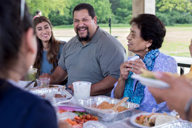 istock Happy man laughs during family meal 1162214955