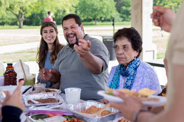istock Mature man laughs during family picnic 1162214959