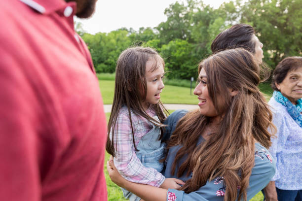 istock Young woman holds her little sister 1162215231