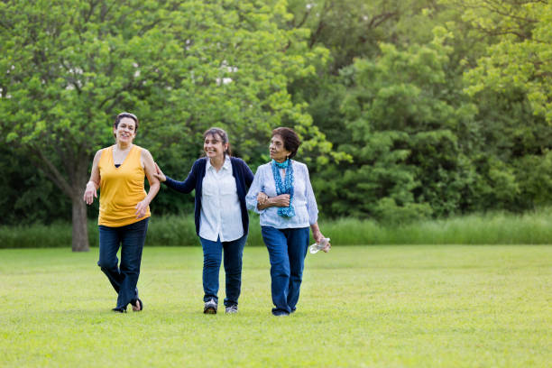 istock Cheerful mom walking with two adult daughters 1162215266
