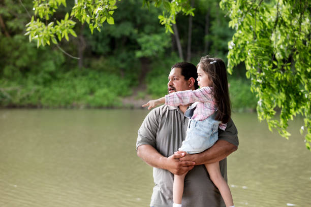 istock Little girl points to something in the water 1162215292