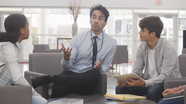 istock Confident male high school teacher mentors students 1162215519