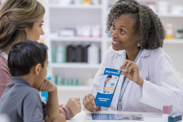 istock Pharmacist shows informational brochure to customer 1162215549