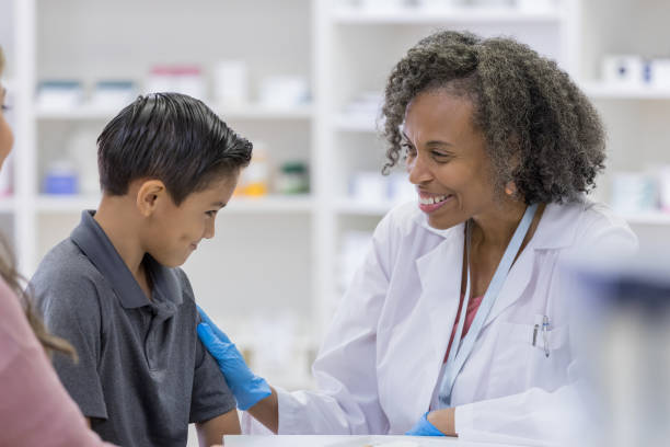 istock Caring pharmacist prepares to give boy flu vaccine 1162215579
