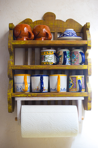 Rustic Southwest USA Kitchen: Cup rack/shelves and paper towel holder. Shot in Santa Fe, NM.