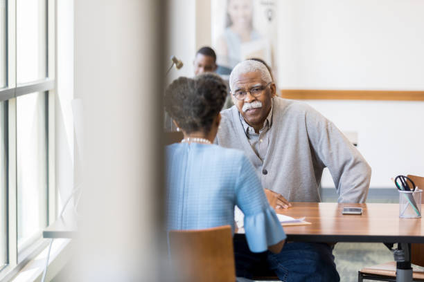 istock Senior man discusses retirement with financial planner 1162215602