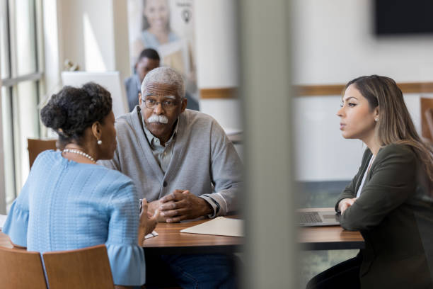 istock Loan officer meets with senior couple 1162215613