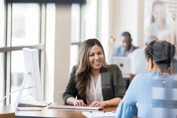 istock Cheerful bank employee opens new account for client 1162215637