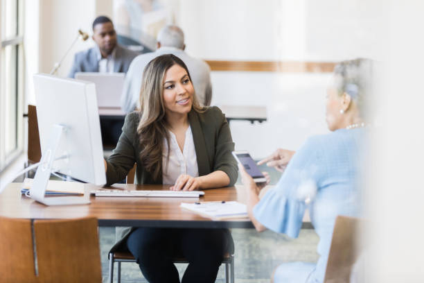 istock Cheerful bank employee opens checking account for customer 1162215641