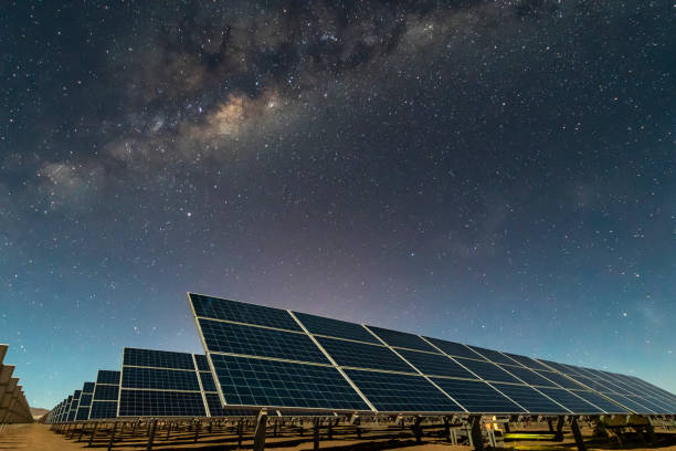 istock Solar Energy Panels view, a nice technology blue pattern at Atacama Desert arid lands. The solar modules going to the infinity with the Milky Way trying to get energy from the stars on the night sky and converting it into electricity an amazing night view 1162223722