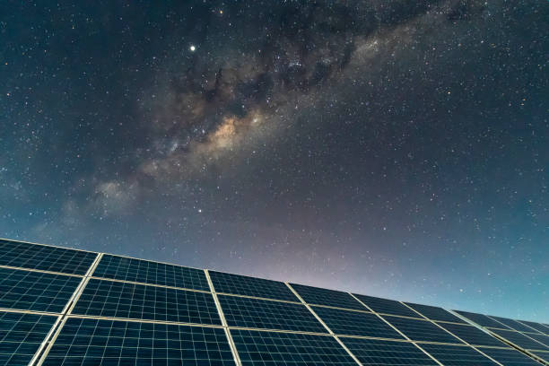 istock Solar Energy Panels view, a nice technology blue pattern at Atacama Desert arid lands. The solar modules going to the infinity with the Milky Way trying to get energy from the stars on the night sky and converting it into electricity an amazing night view 1162223750