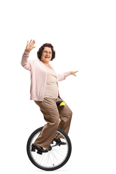 istock Super grandma riding a unicycle and waving 1162226270