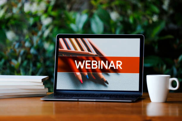 istock Laptop with webinar screen on wooden desk 1162227306