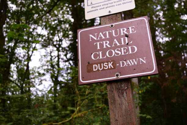 istock Close Up Opening/Closing Sign Within Forest At Priest Point Park 1162228347